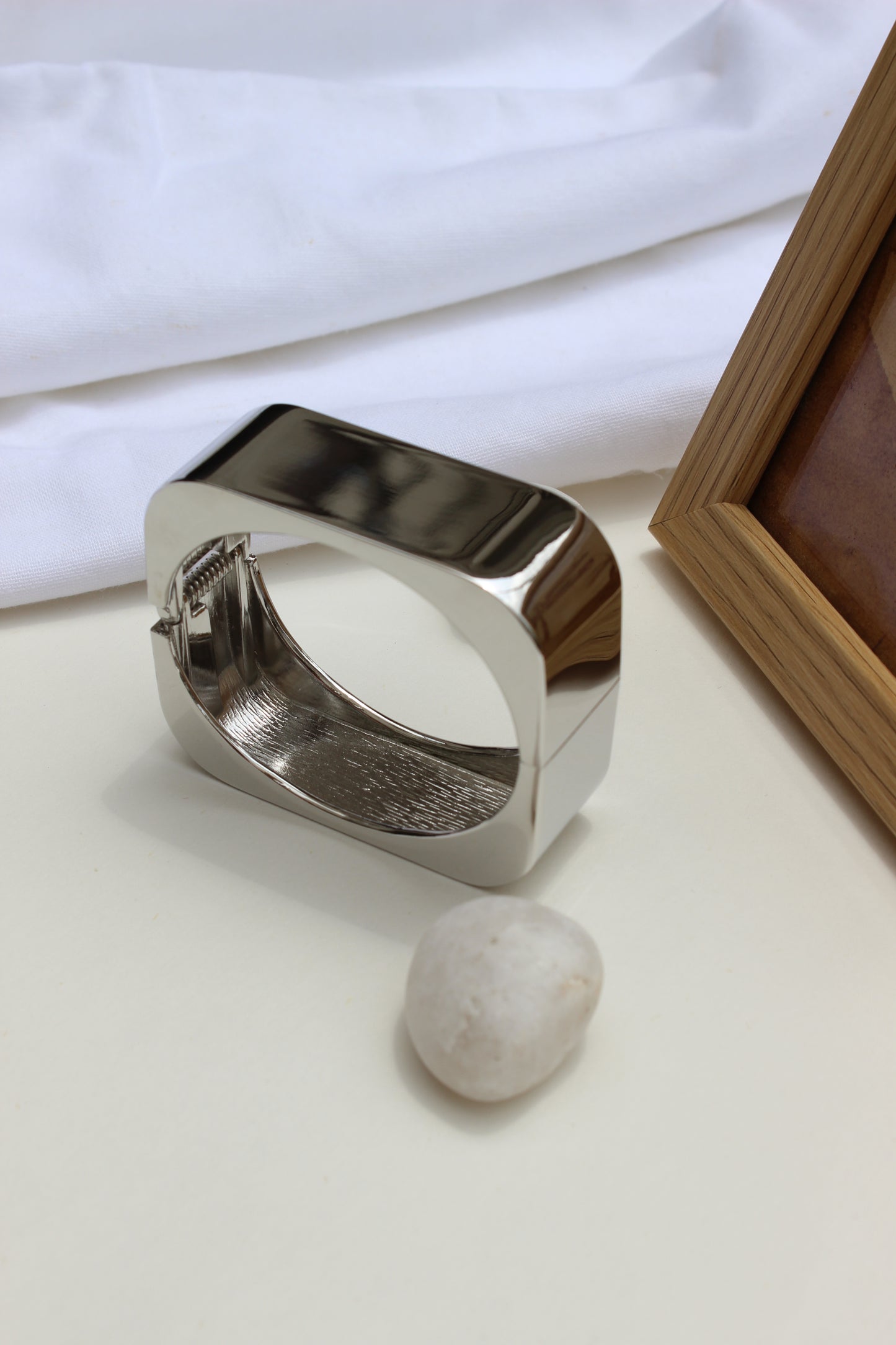 Lucid Hour Bracelet on a white surface with a blurred background