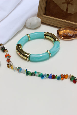 Colorhug Bangle Bracelets on a white surface nearby white fabric