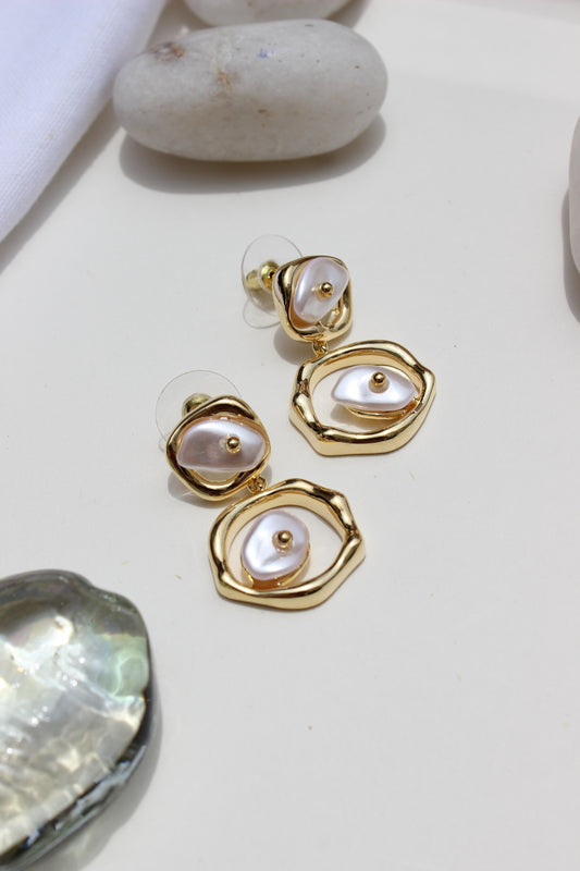 Sea of Silence Earrings on a light background with shells