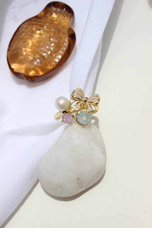 Saltbloom Ring with pearls and gold elements on a white fabric background