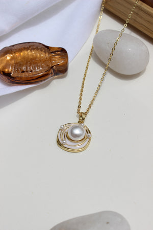 Bound in Pearl Pendant Necklace on a white surface nearby seashell