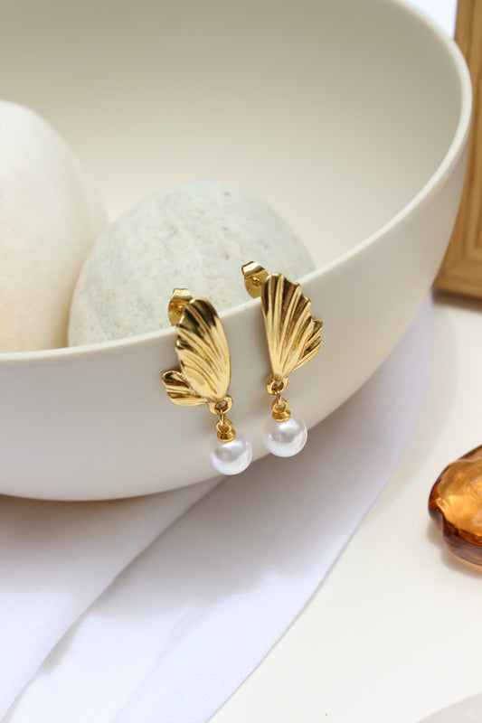 Lunar Drip Earrings with pearls on a white dish
