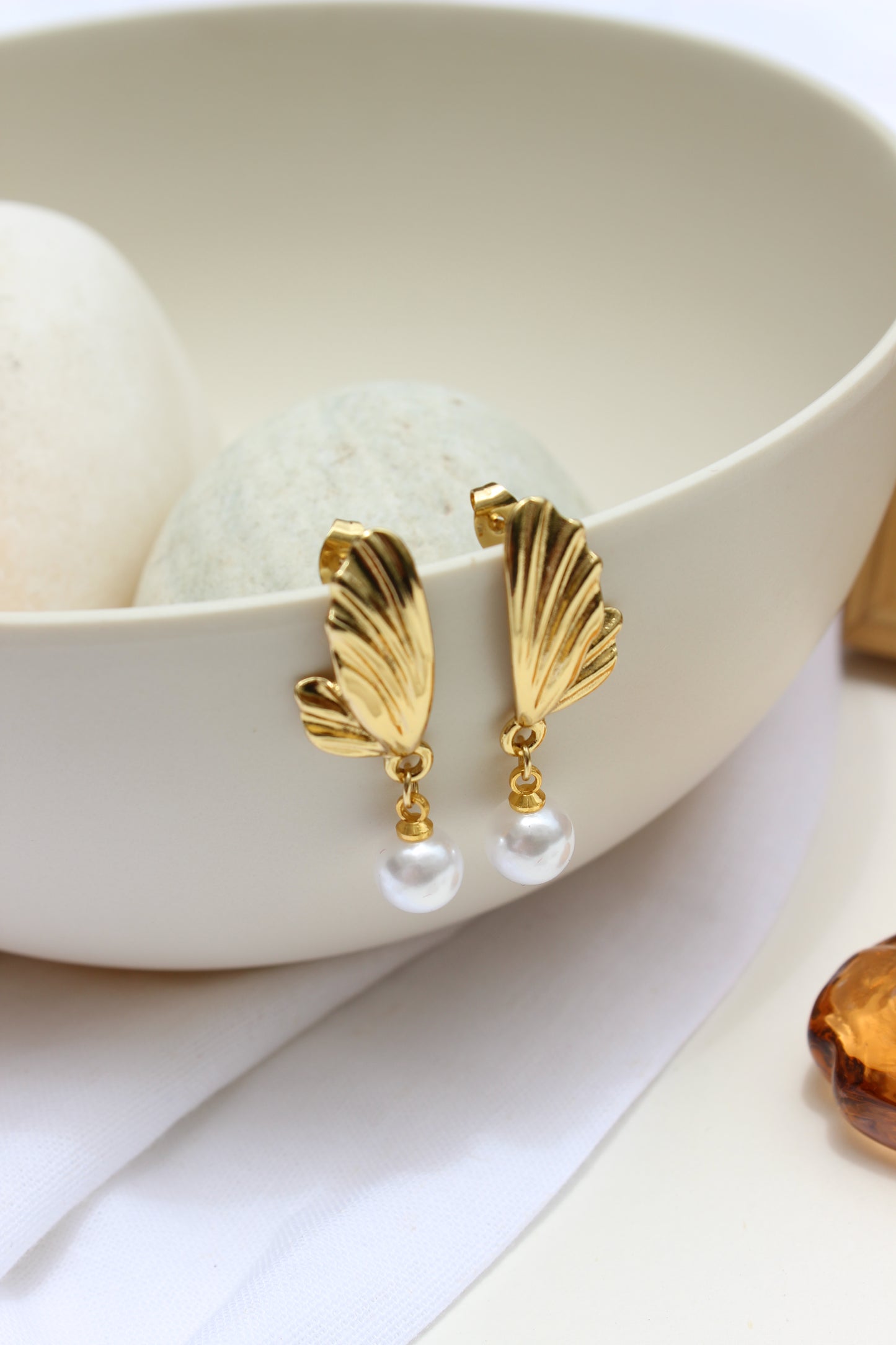 Lunar Drip Earrings on a white dish with a white background