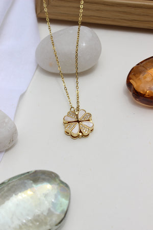 Oyster Petal Pendant Necklace on a white surface with stones