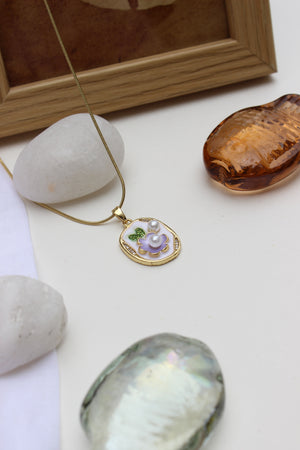 Nature-inspired dainty floral necklace with gold frame and purple flower charm