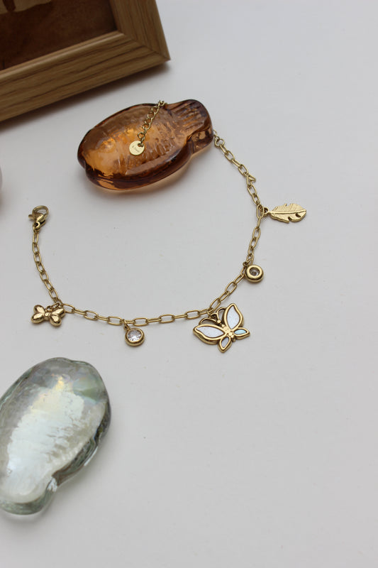 Honey & Moonlight Charm Bracelet on a light gray background with decorative stone