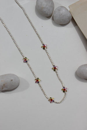 Floranta Necklace with colorful gemstones on a light surface with stones