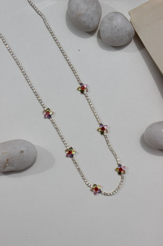 Floranta Necklace with colorful gemstones on a light surface with stones