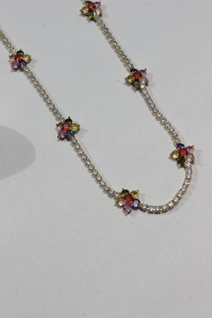 Floranta Necklace with floral designs and colorful stones on a white background