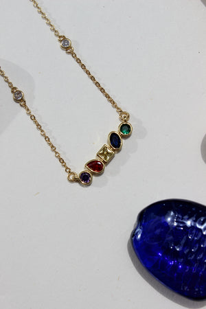 Carry Light Pendant Necklace on a white surface nearby seashell