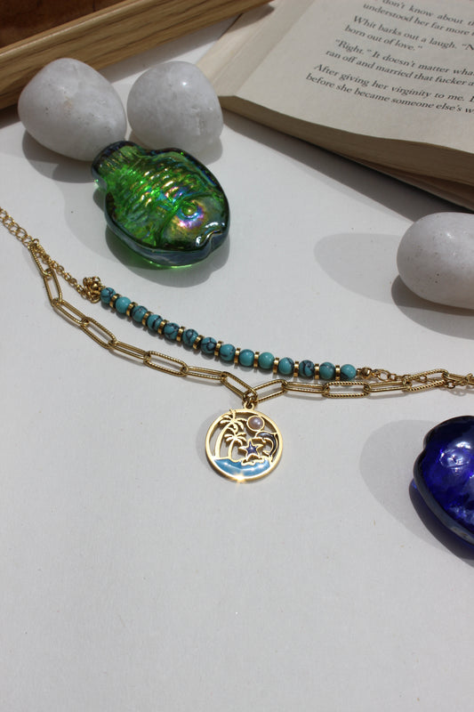 Ocelette Layered Bracelet on a white surface with books and decorative stones