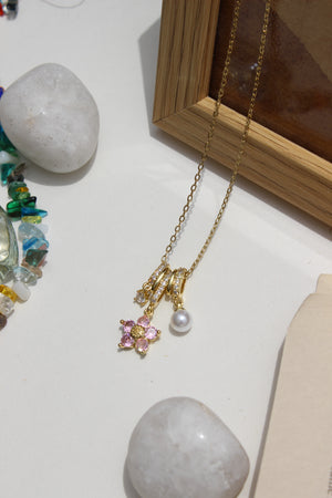 Twinkle Flora Charms Pendant Necklace on a white surface