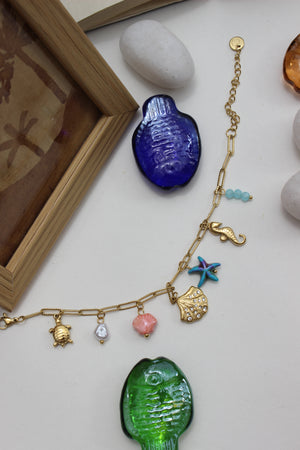 Oricca Charms Bracelet on a white surface with decorative stones