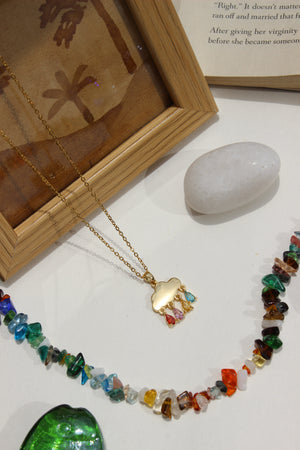 Skydrops Pendant Necklace with a gold clasp on a white surface