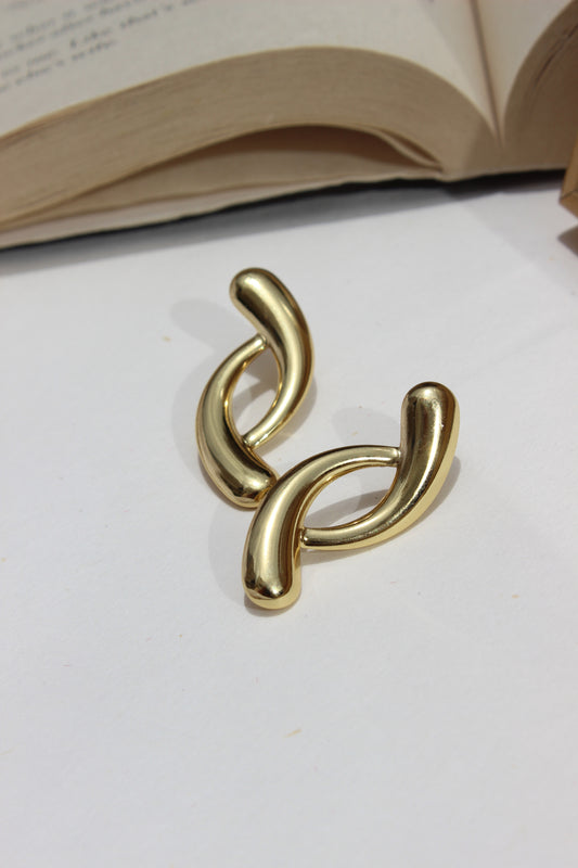 Lushline Earrings on a white surface with a blurred background