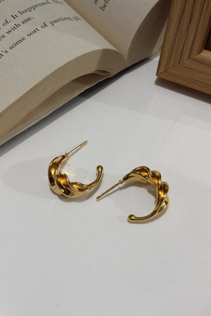Sunspell Earrings on an open book with a white background