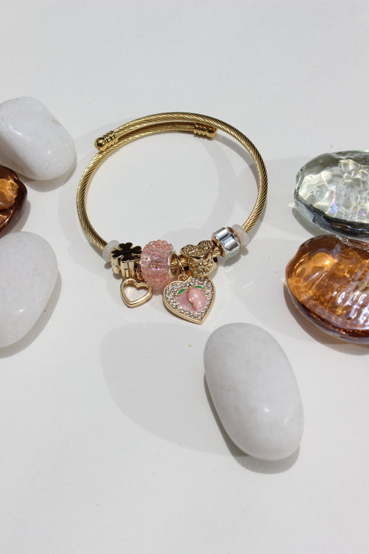 Lovelune Charms Bracelet with a pink heart charm on a white surface