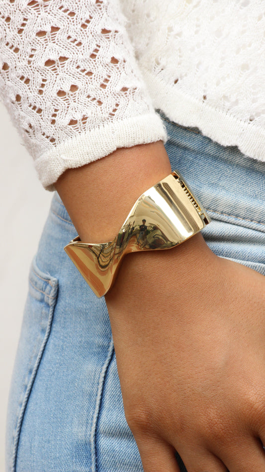 Molten Curve Bracelet on a wrist with denim and lace clothing in the background