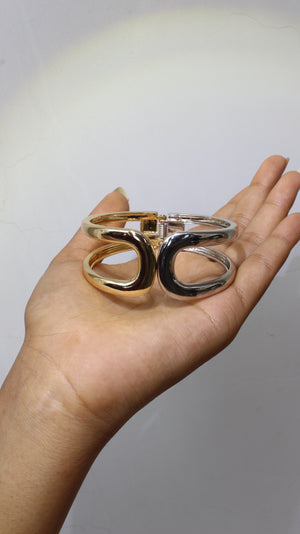 Hand holding a set of gSoft Armour Bracelet against a neutral background