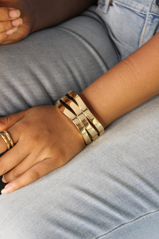 Close-up of a model's arm wearing Tide Warp Bracelet on a gray background