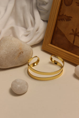 Monarch Cuff Bracelet on a neutral background with stones and fabric