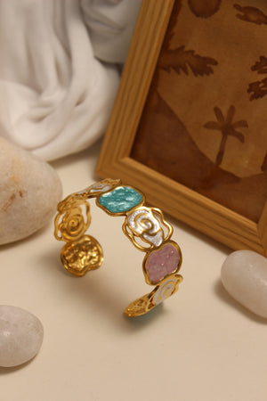 Pearled Blossom Cuff Bracelet with colorful stones on a textured surface