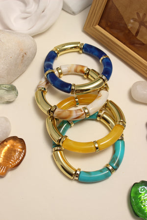 Seaglass Bangle Bracelets on a neutral background with stones and shells