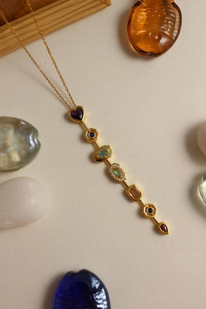 Amour Pour Necklace on a light surface