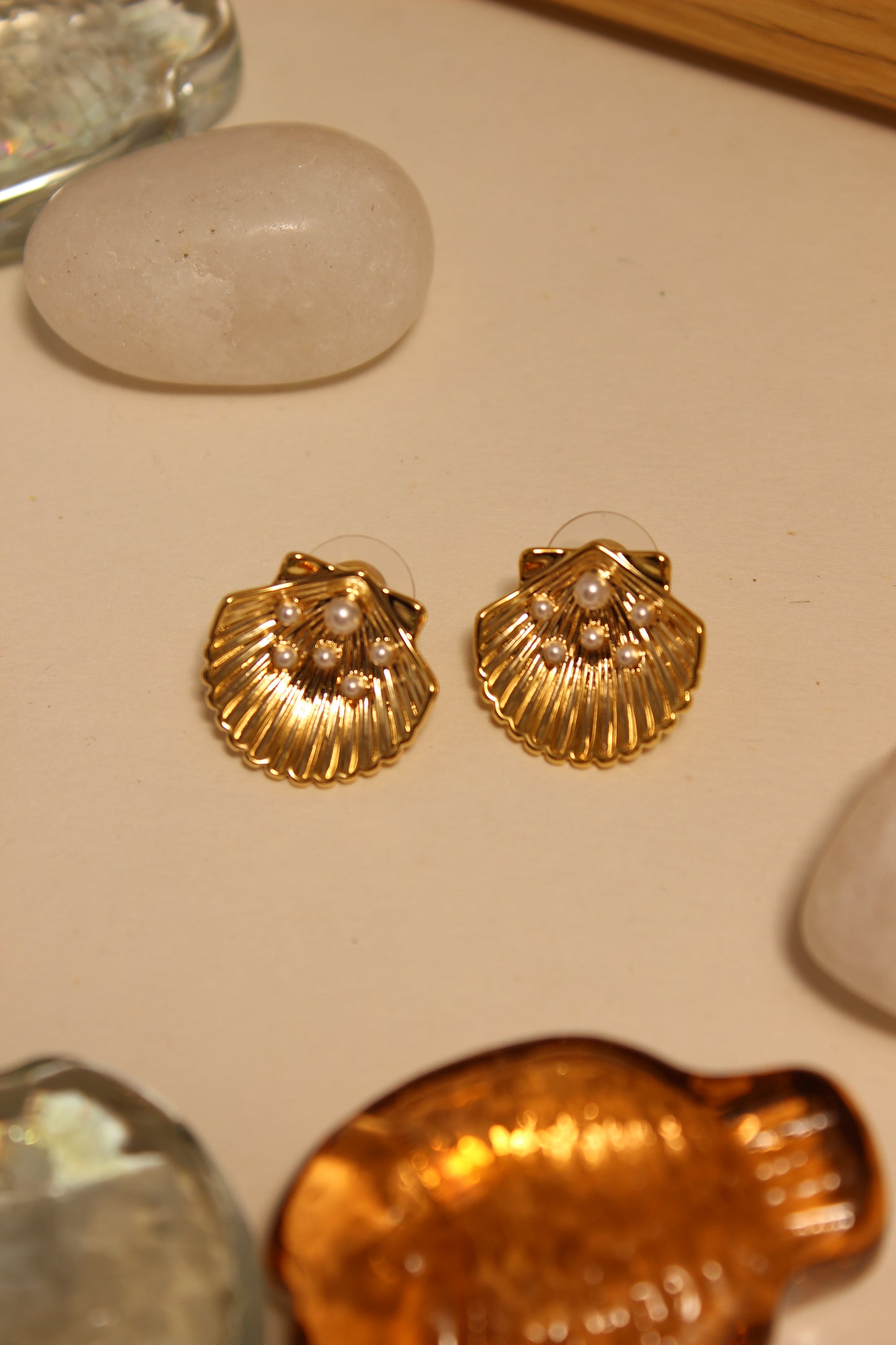 Sunset in Bloom Stud Earrings on a beige surface