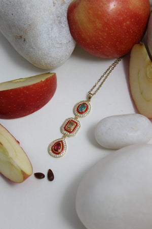 Empress Flame Necklace on a white surface
