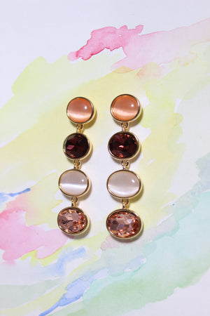 Blush Radiance Earrings on a watercolor background