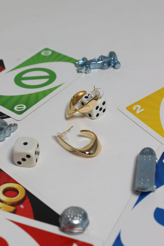 Lunelle Half Hoop Earrings on a board game piece with dice