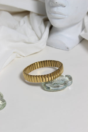 Timeless Gleam Bracelet on a white surface with marble-like texture