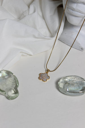 Moonflower Pendant Necklace on a white fabric background