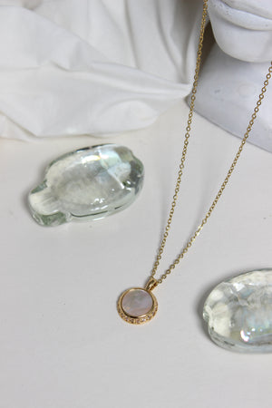 Iridesca Pendant Necklace on a white surface