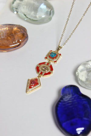 Inferno Charm Necklace on a light gray background