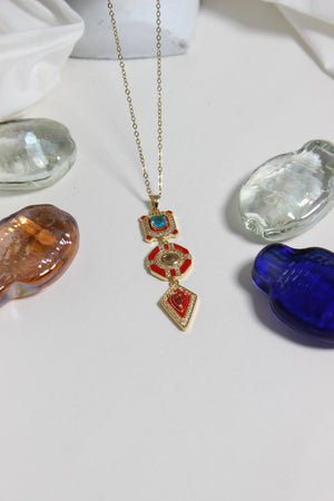Inferno Charm Necklace on a white surface