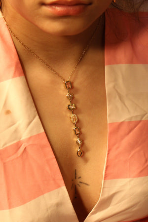 Close-up of a model wearing a Blush Pastel Pour Necklace with a blurred background
