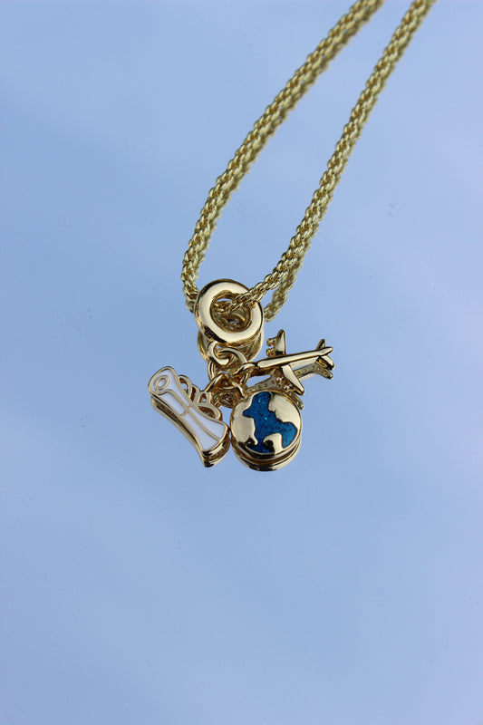 Jet Set Dream Charm Necklace on a blue background