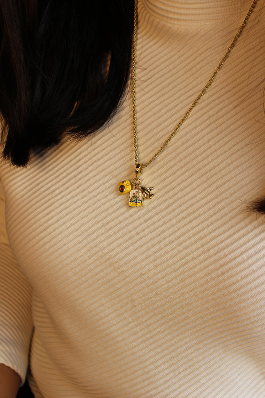 Happy Trails Charm Necklace on a textured beige surface