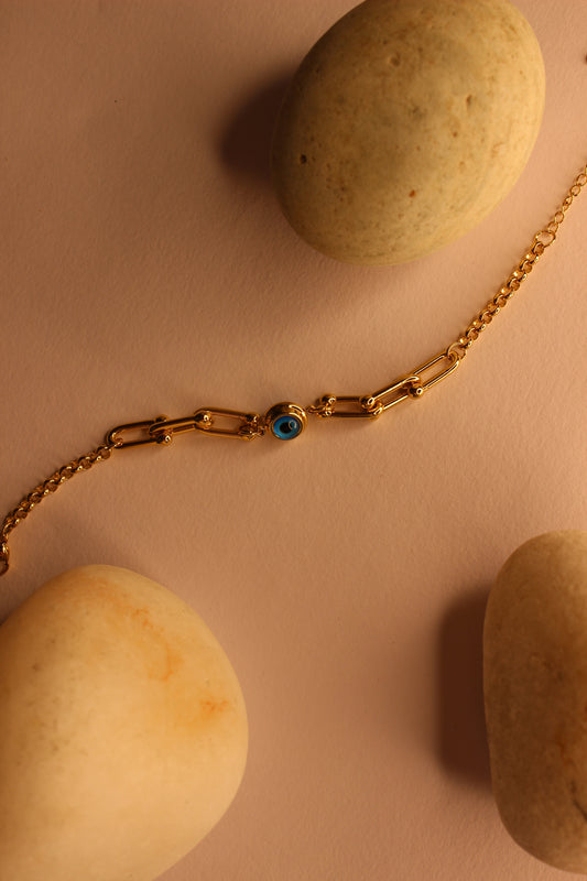 Pelora Bracelet on a beige surface with stones