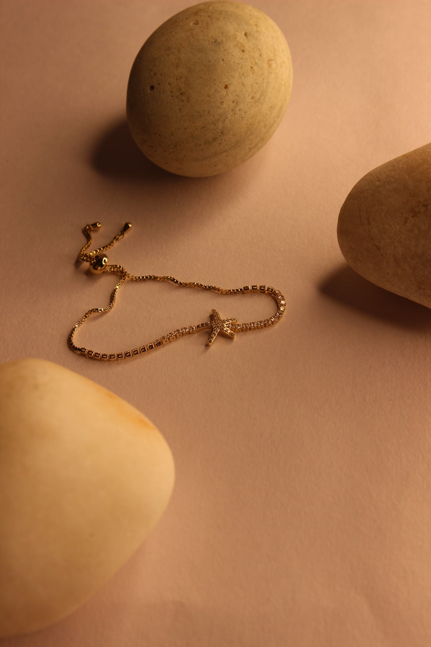 Maristar String Bracelet on a pink surface with stones