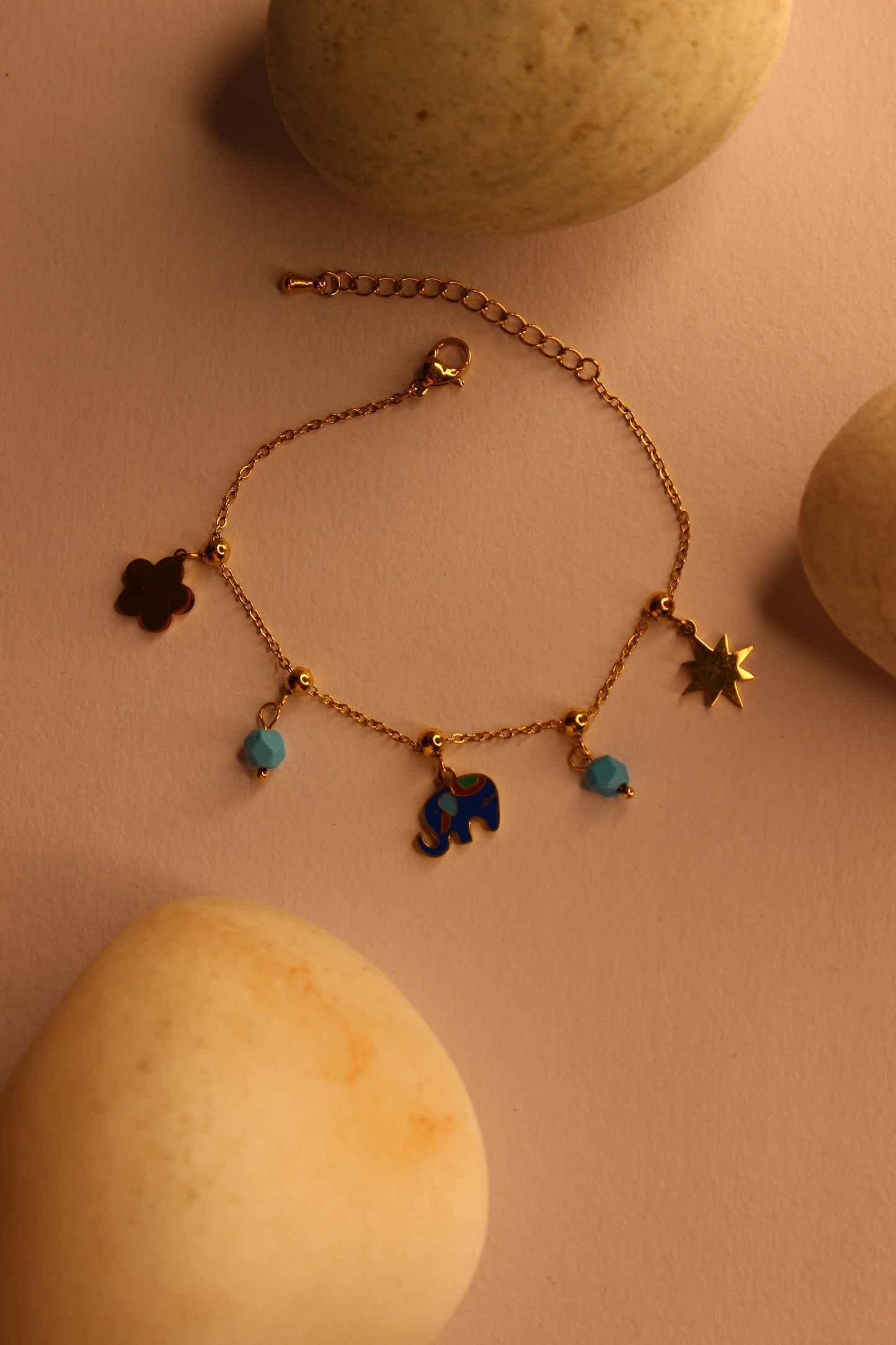 Wishkeeper Charms Bracelet on yellow background with decorative stones, stylish women's jewelry