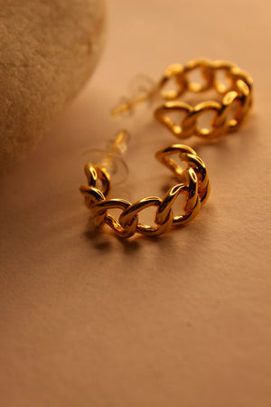 Gold chain-style Tied in Gold Hoop Earrings on a beige background