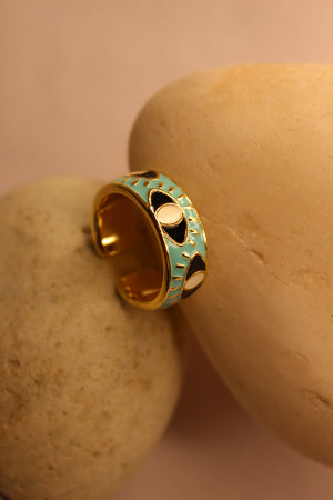 Nazare Ring with turquoise band on a beige stone background
