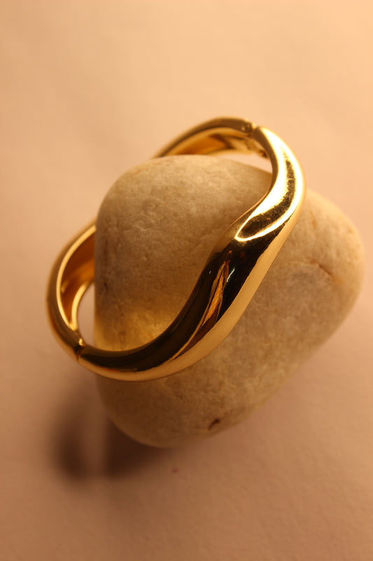 Velda Bracelet on a beige stone surface