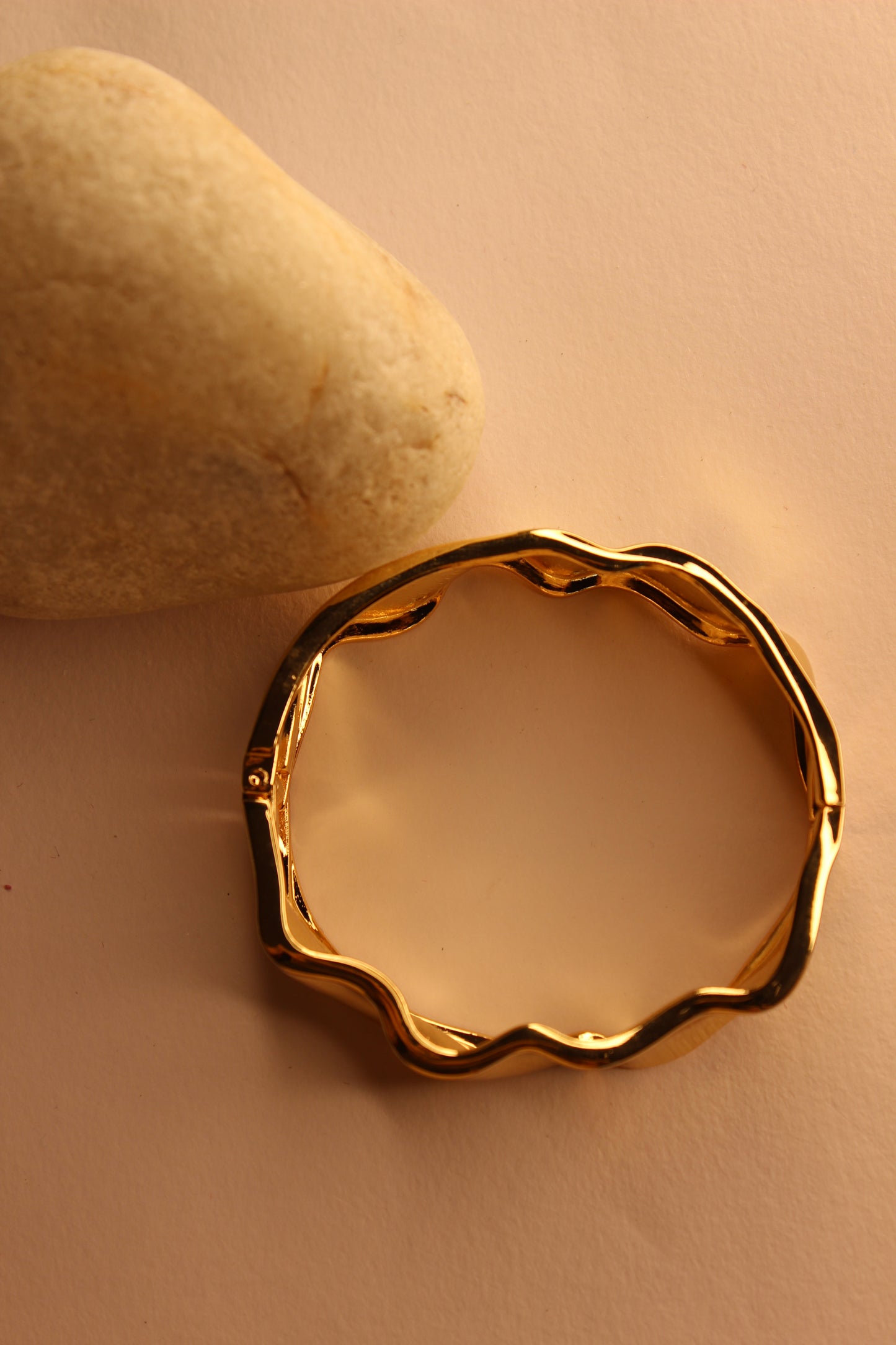 Liora Bracelet on a beige stone with a soft focus background