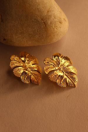 Leafora Earrings on a beige surface