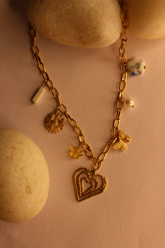 Hearts in Bloom Charms Necklace on a beige background