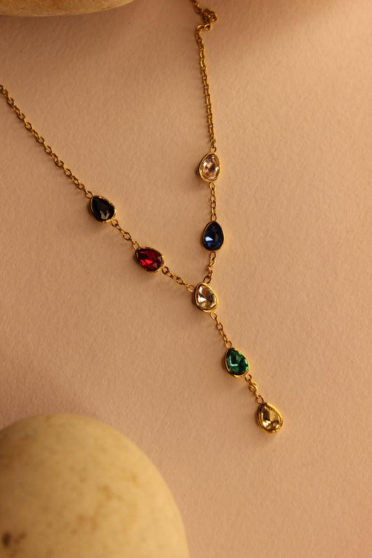 Prism Drop Necklace on a beige background